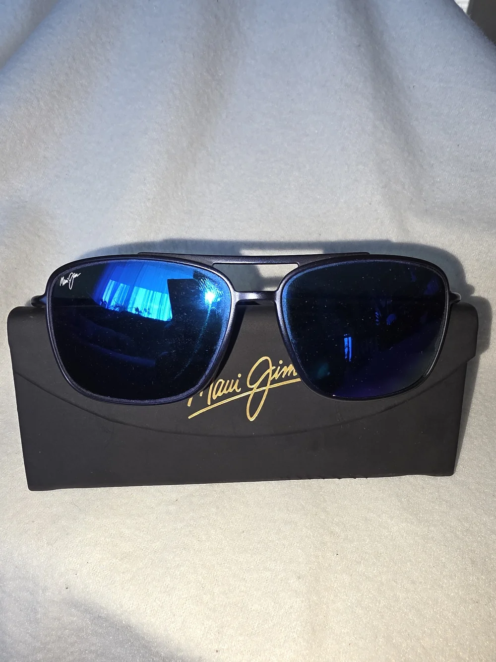 Maui Jim Kaupo Gap sunglasses featuring a matte black frame with blue mirrored